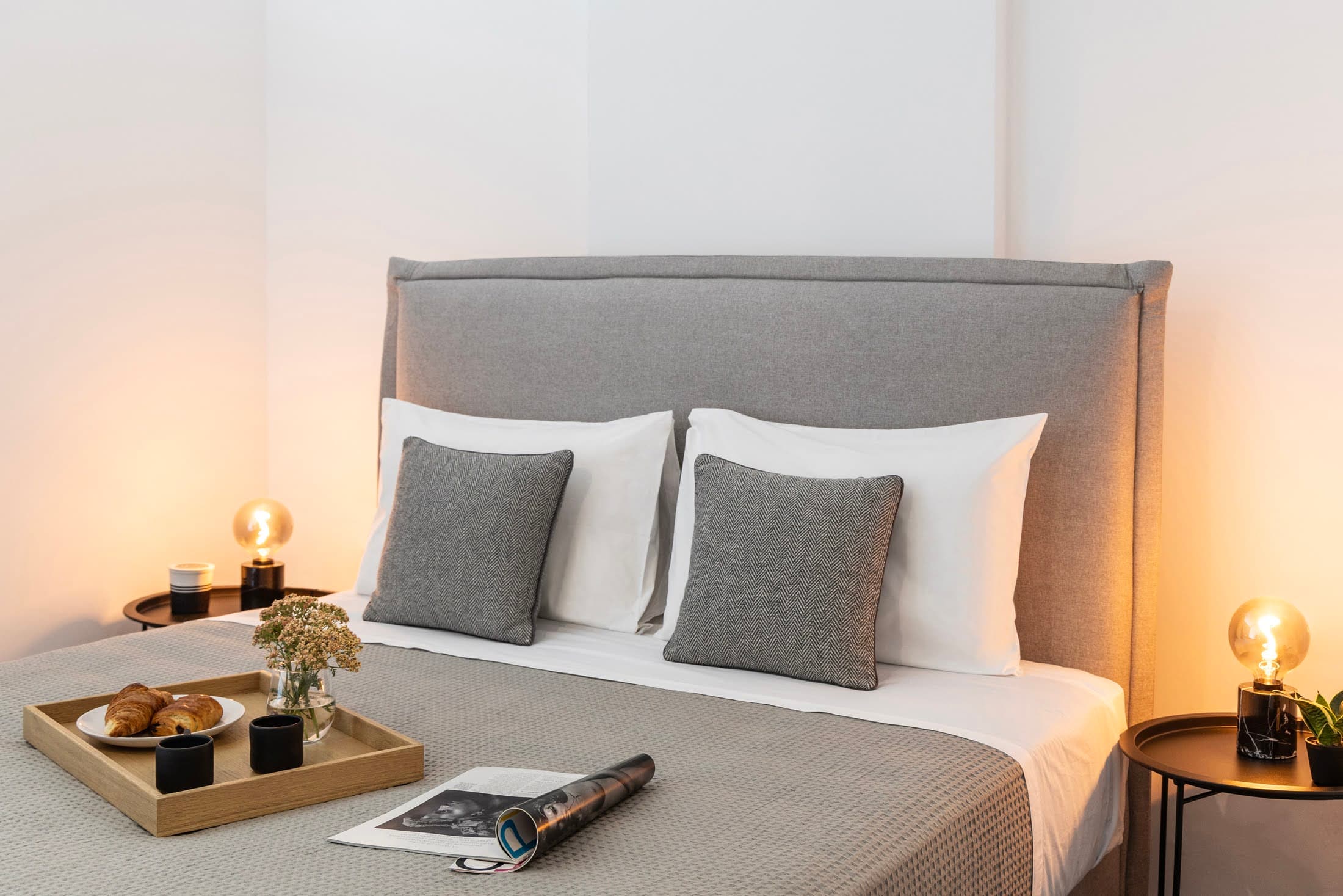 Bright bedroom with warm bedside lighting